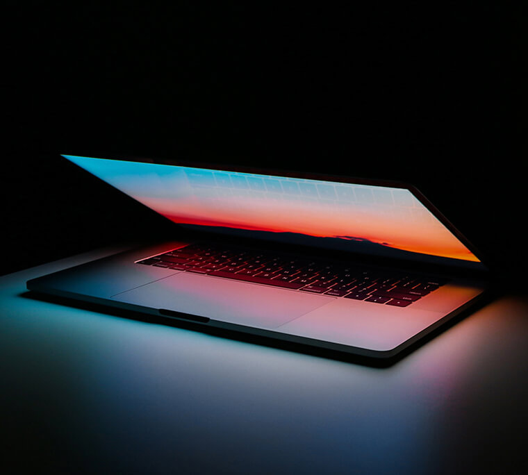 Open turned on laptop in a dark room