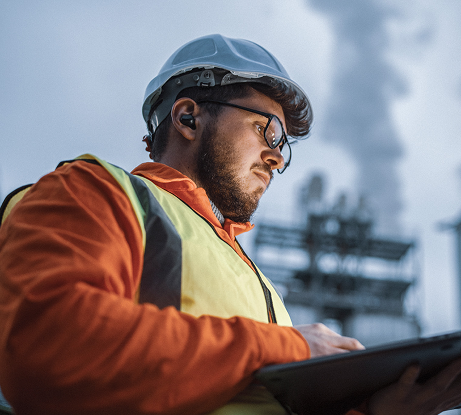 engineer using a laptop while working in the oil and gas industry