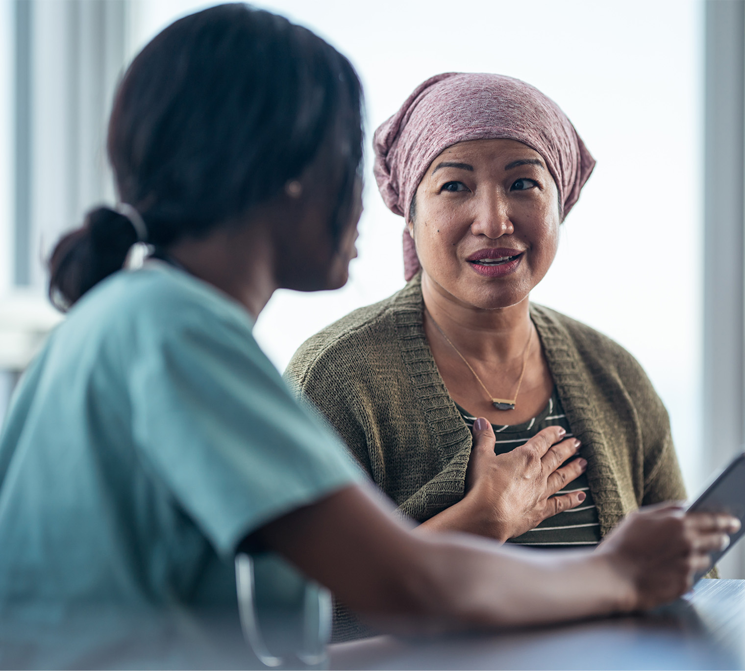 nurse speaking with cancer patient