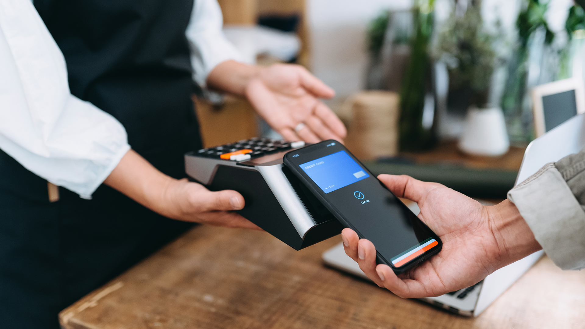 Person paying for goods using their phone