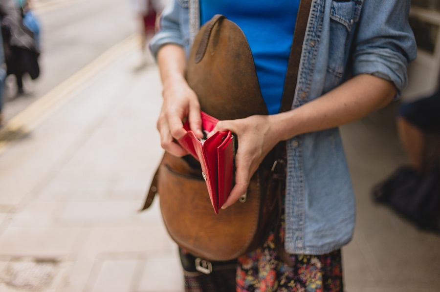 Woman looking into empty wallet