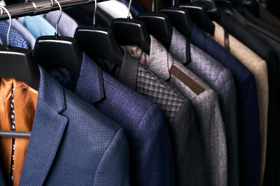 Row of men's suits on hangers