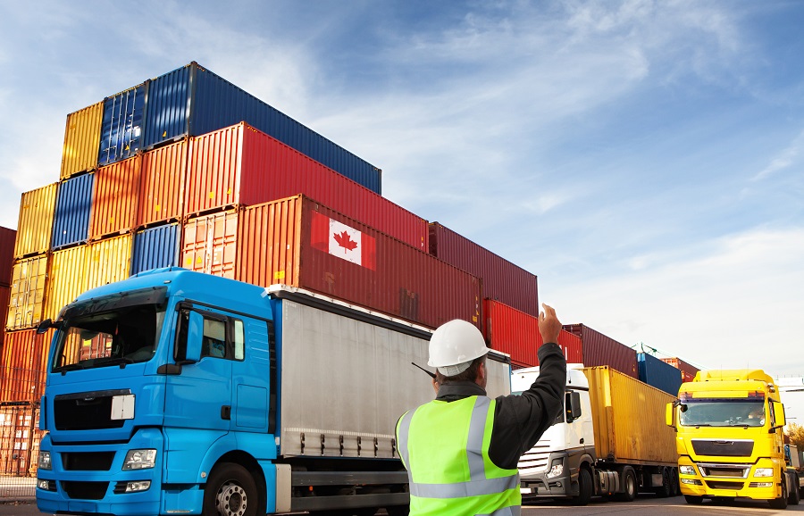 Man waving in semi trucks in shipping yard