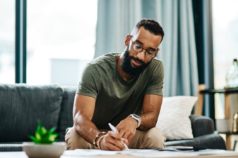Man working on coffee table at home