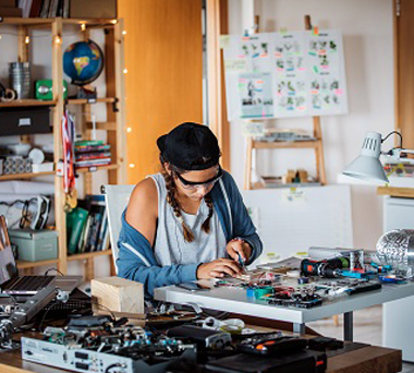 Woman fixing electronic equipment