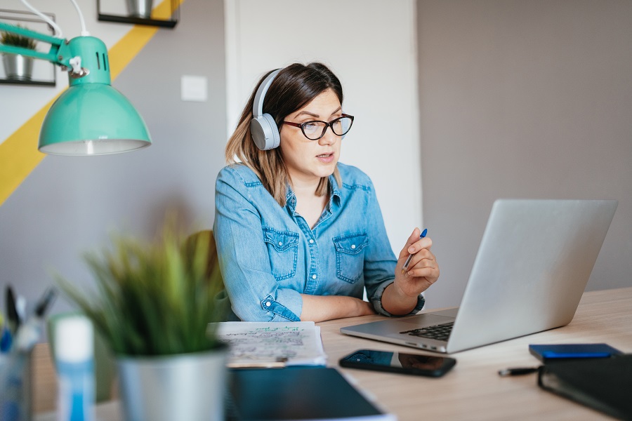 Businesswoman having teleconference call with colleagues