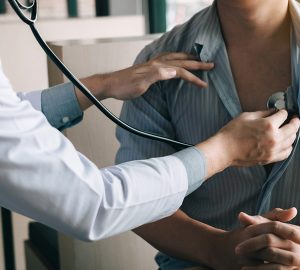 doctor is using a stethoscope listen to the heartbeat of the elderly patient