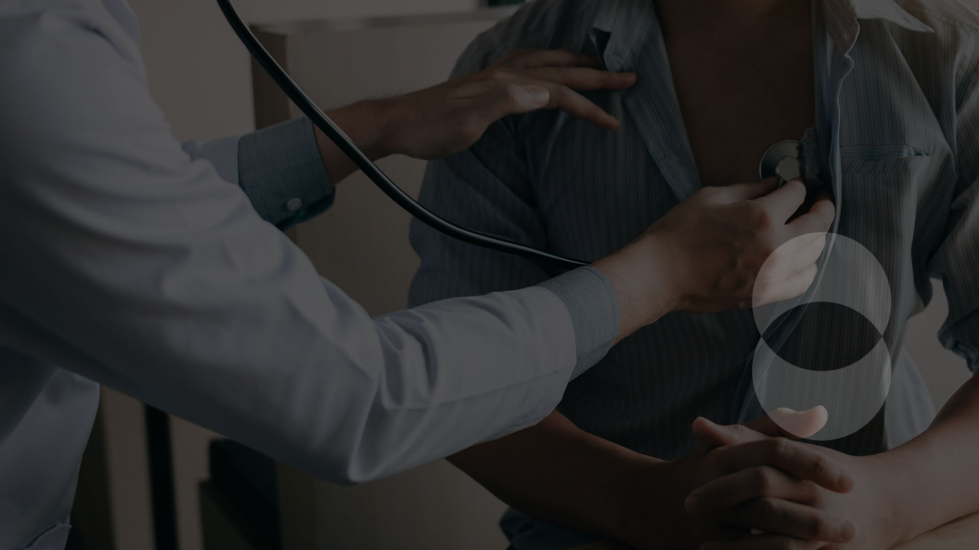 Doctor is using a stethoscope listen to the heartbeat of a patient.