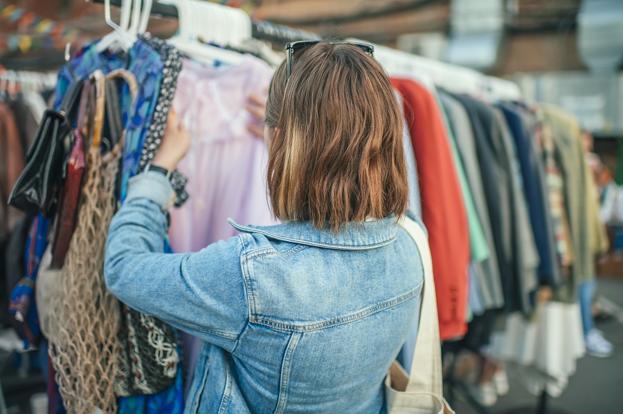 Woman looking through rack of clothing