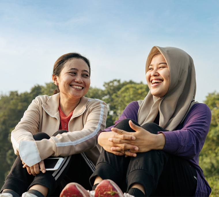 two woman laughing, two woman talking, two people