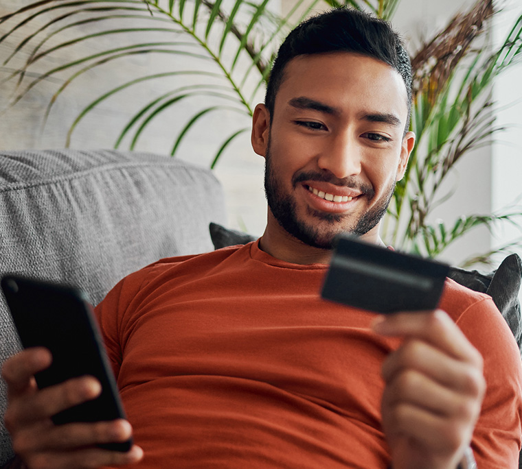 man paying bills online, man with credit card, person with credit card, person paying online