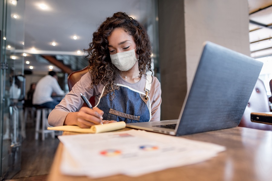 Masked woman working in a store