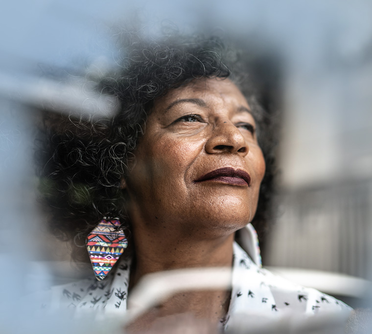 woman looking out, woman looking outside, older woman