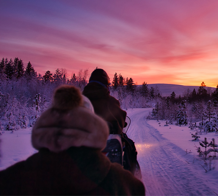 With the snowmobile into the snowy dawn