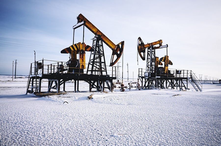Pump jacks in field during winter