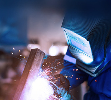 Welder in helmet at work