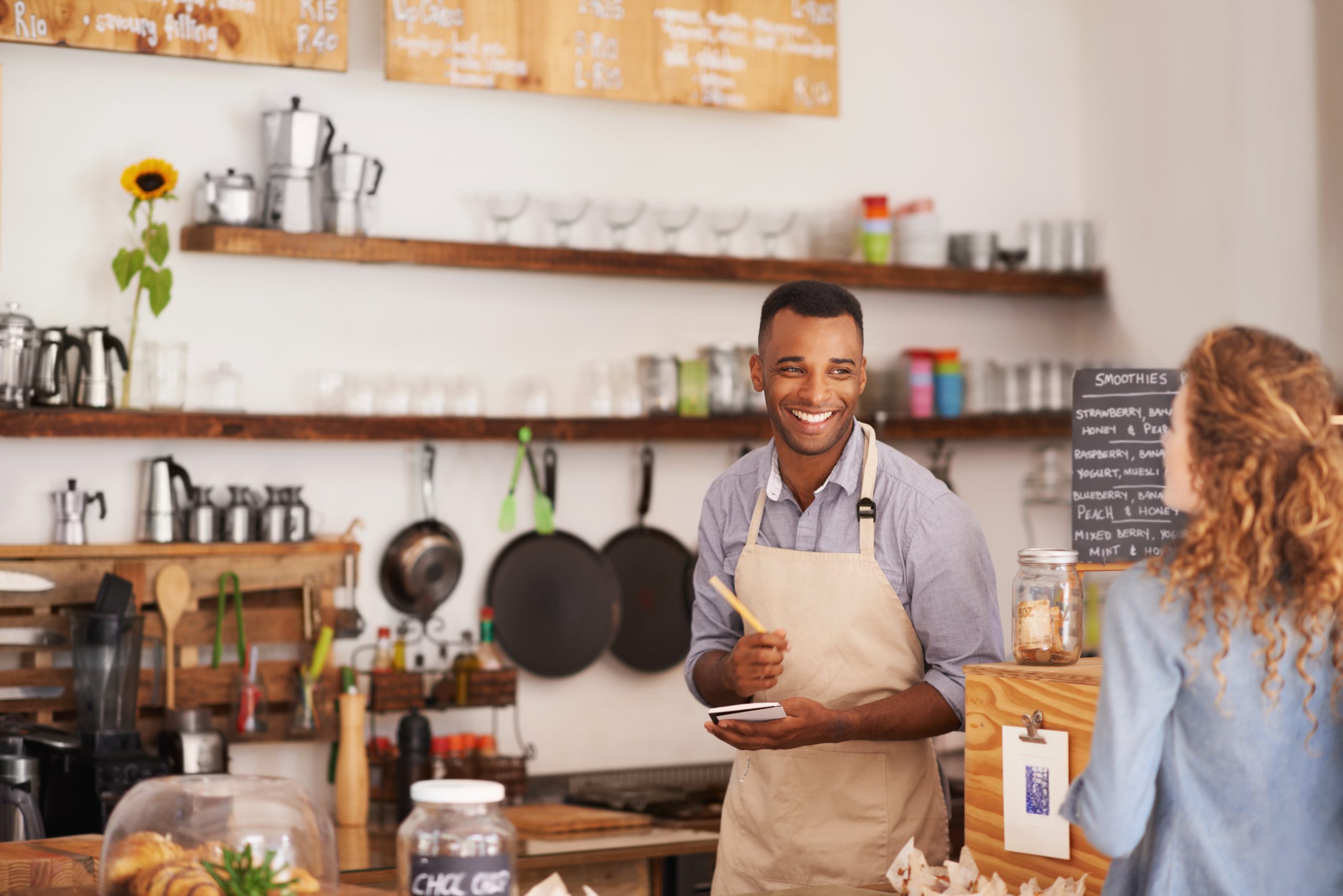 Smiling man takes woman's food order