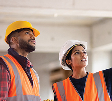 Two construction workers in empty space