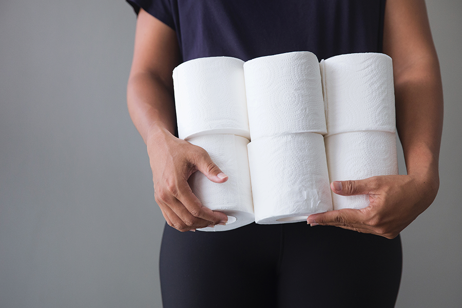 Person holding 6 rolls of toilet paper