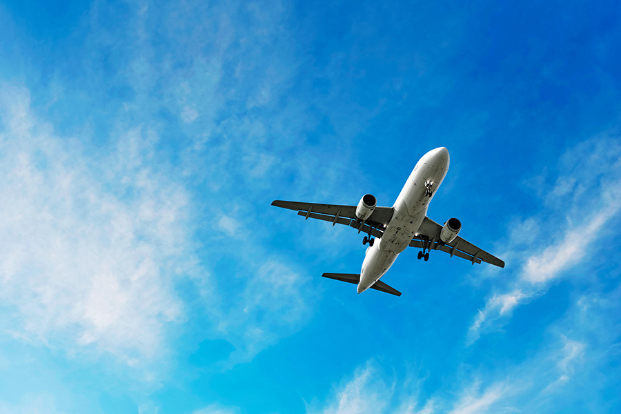Jet airplane flying overhead in clear sky