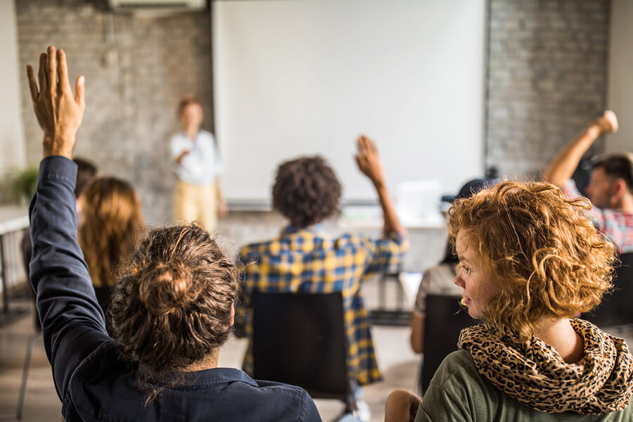 Women with raised hands in a workshop