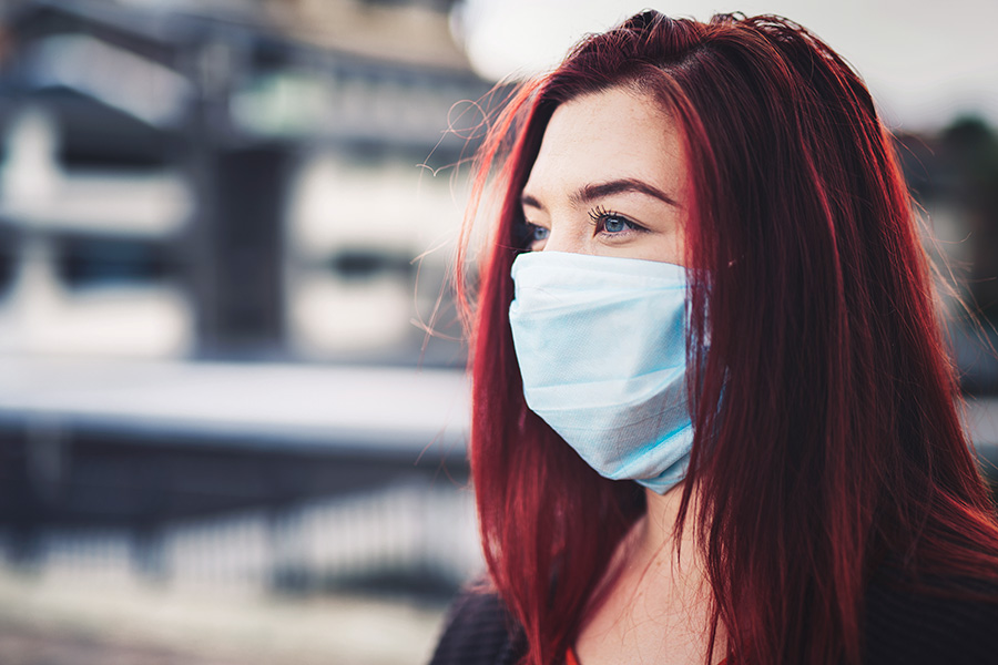 Masked woman out of doors