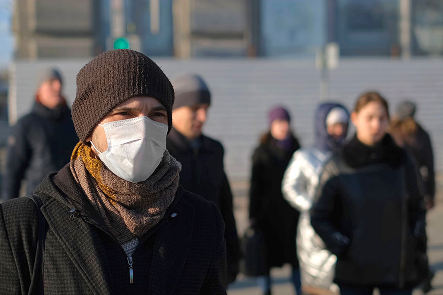 Group of masked people standing outdoors