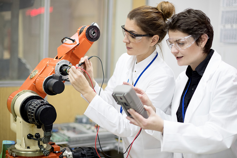 Two scientists working with microscope