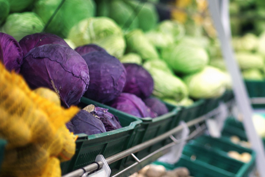 Baskets of cabbages at a grocery store
