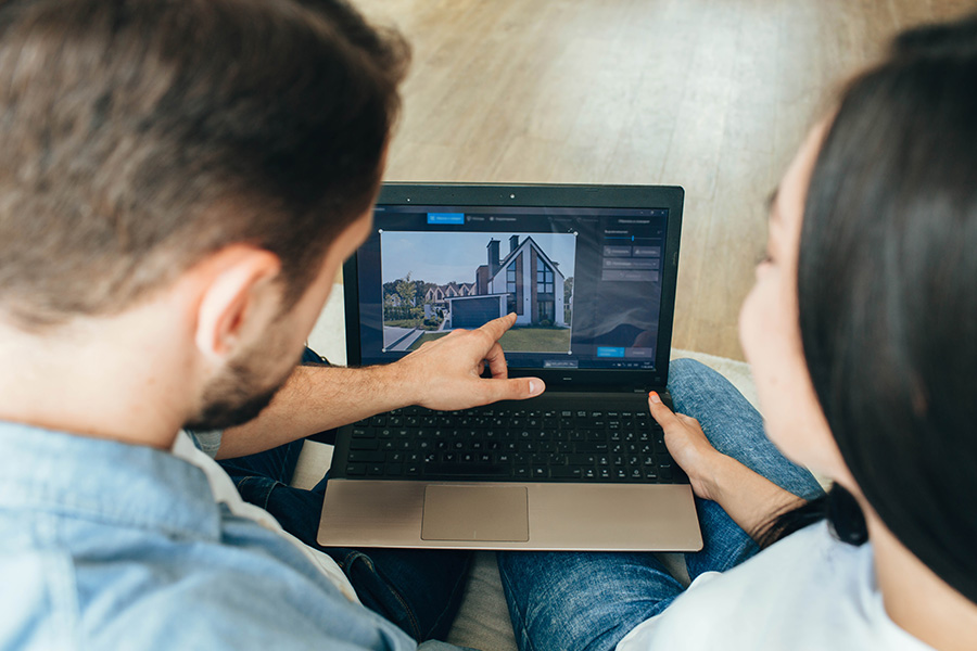 Couple viewing real estate listings on a laptop