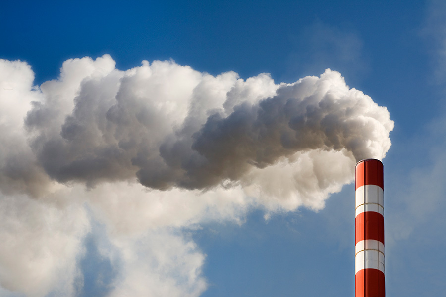 Clouds billowing from smoke stack