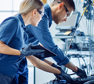 Mechanics working on car engine