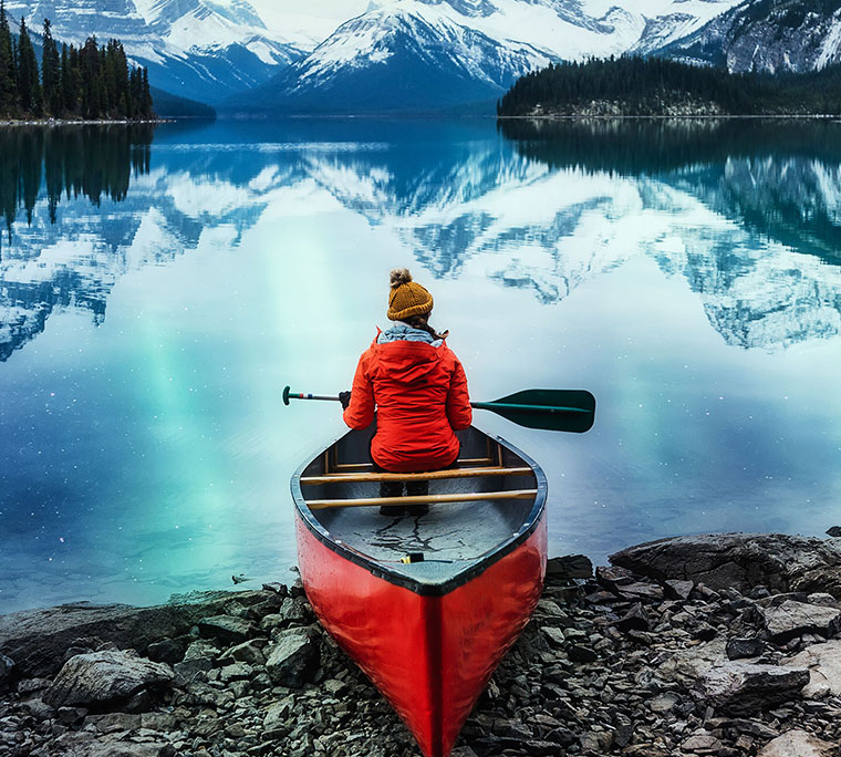 Female traveler on canoe at Jasper National Park.