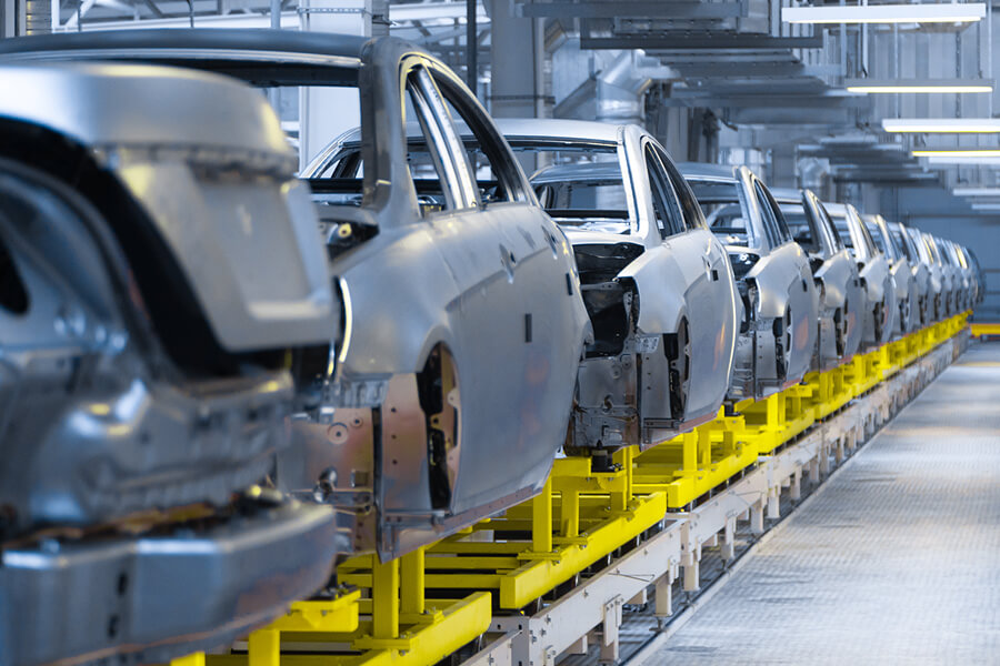 Partially built cars on assembly line