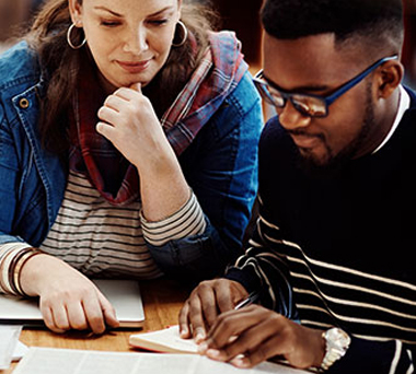 Two people studying in a library