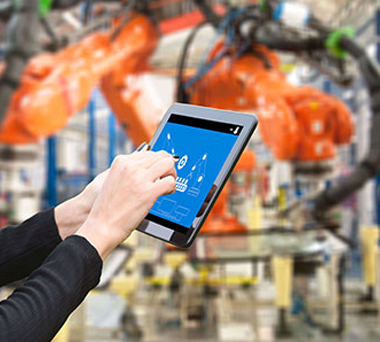 Hands using tablet in industrial setting