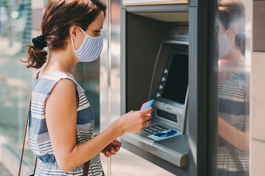 Woman using bank machine