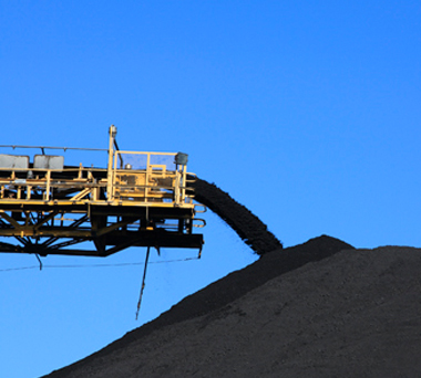 Machine pouring dirt onto a pile