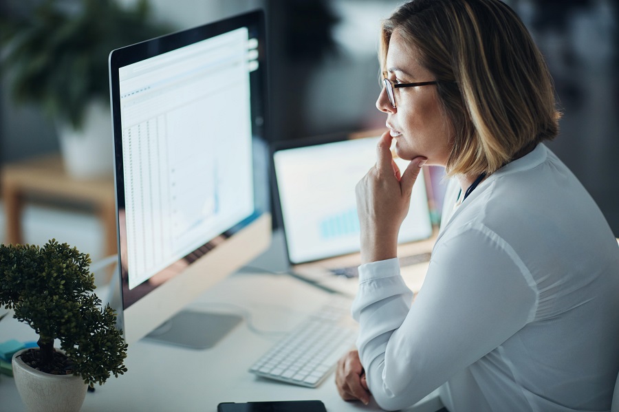 Concerned woman looking at computer screens
