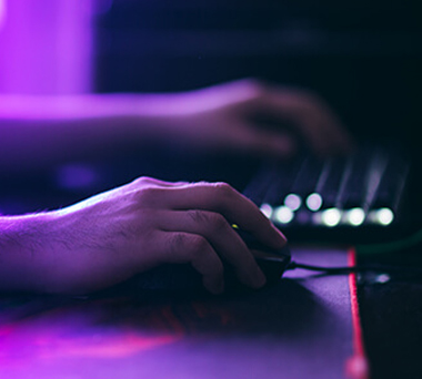 Hands holding mouse and using keyboard