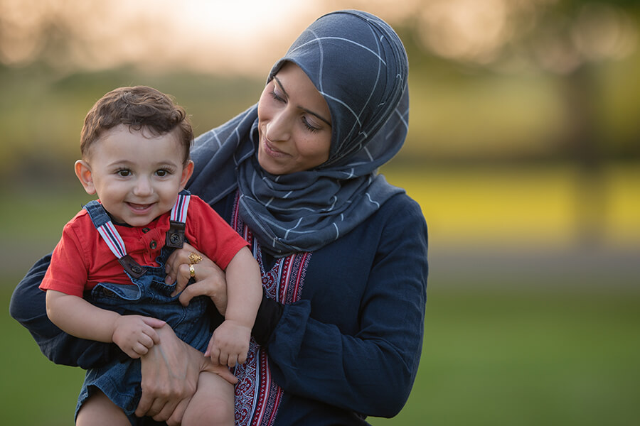 Mother holding young son in her arms