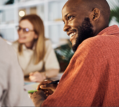 Smiling man and woman in a meeting