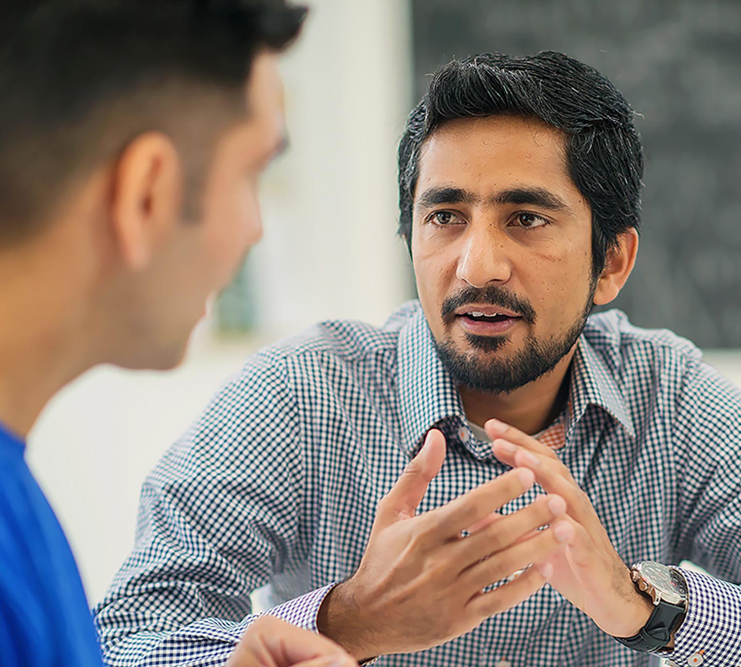 immigrant worker talking with colleague