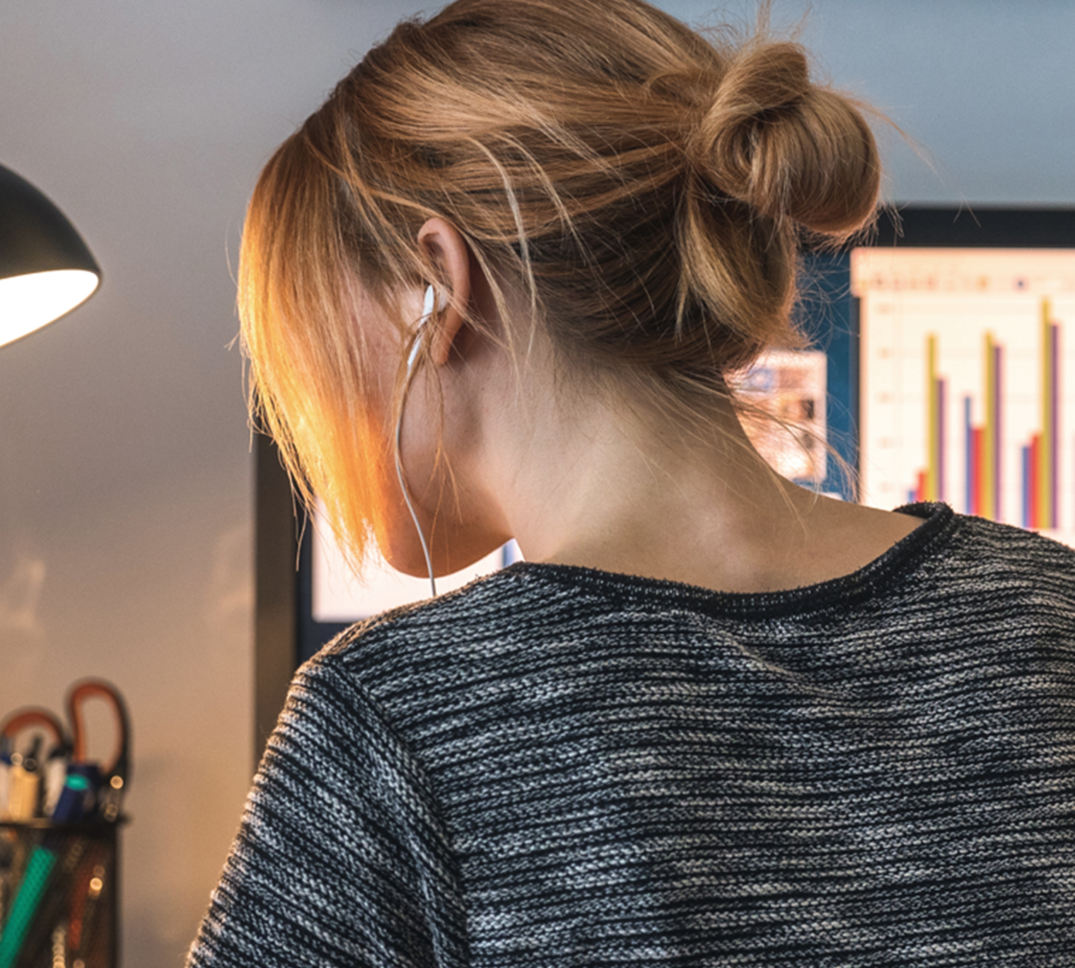 Woman sitting at desk working from home.