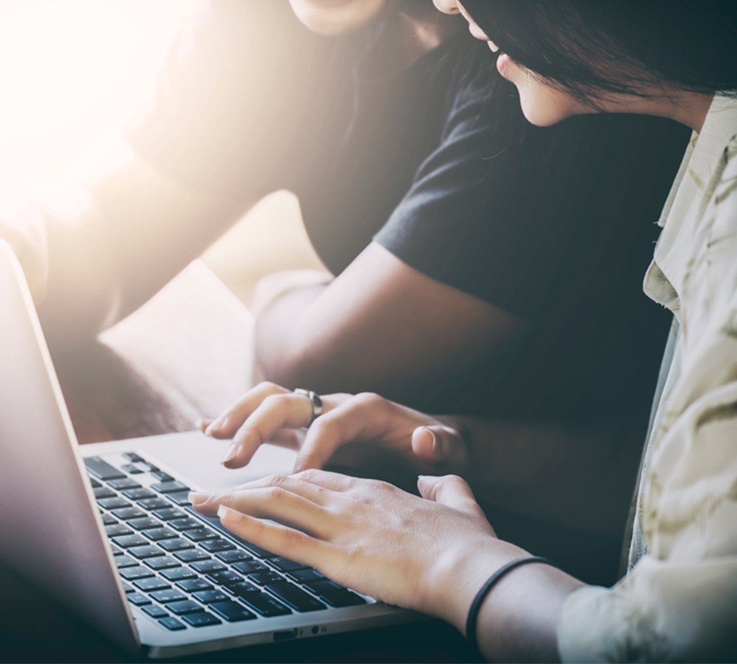 Woman and man looking at laptop screen.