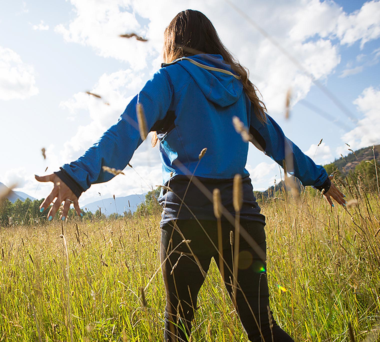 Canadian First nation woman walking in a field.