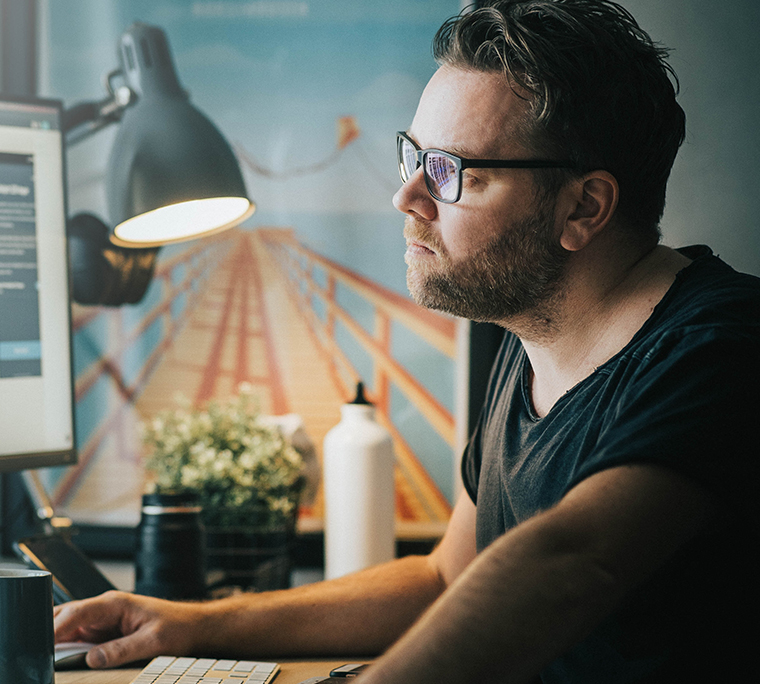 Man at desk on his computer.