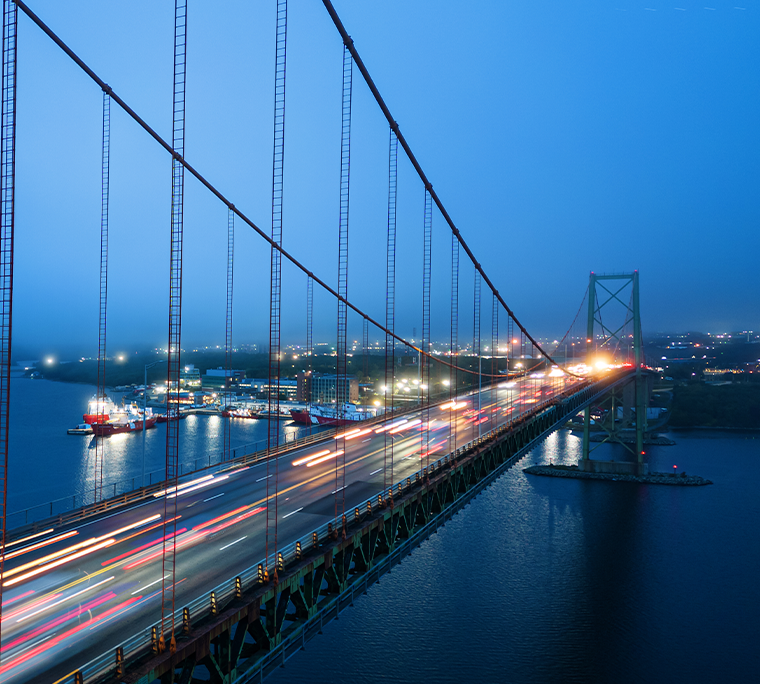 cars driving across a bridge to Halifax at night