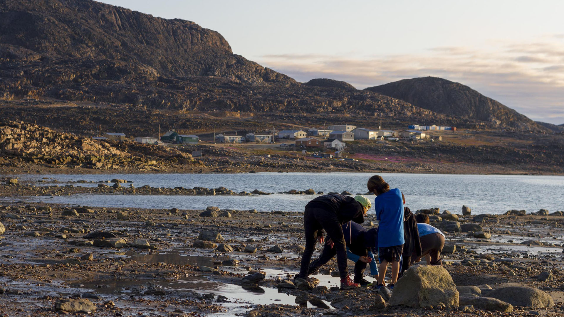 Indigenous children playing on the low-tide shore line.
