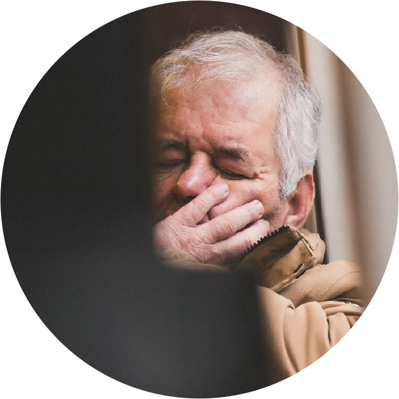 person sitting with hand on face looking very defeated